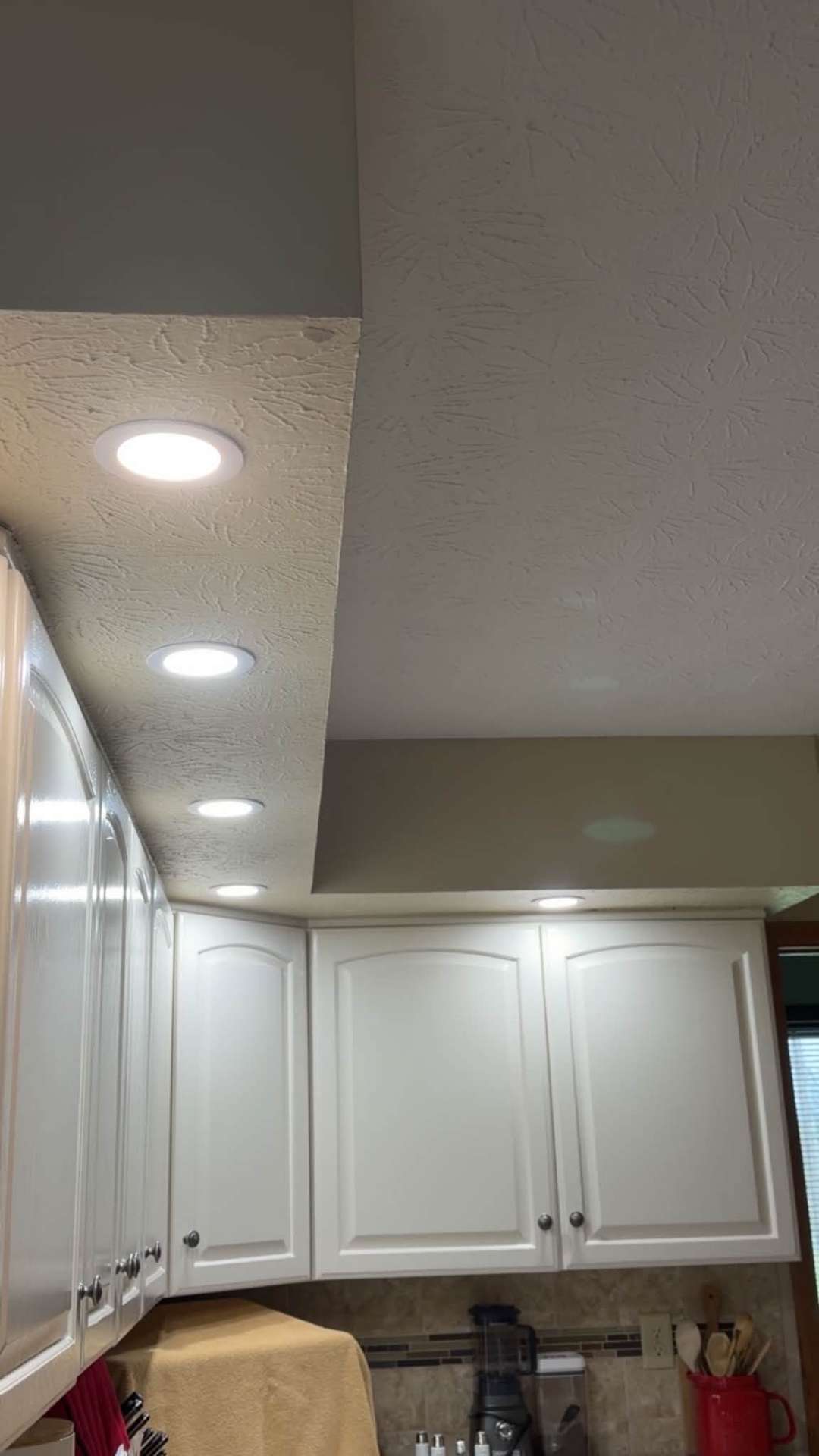 Recessed LED lighting installed above kitchen cabinets by Warren's Electric